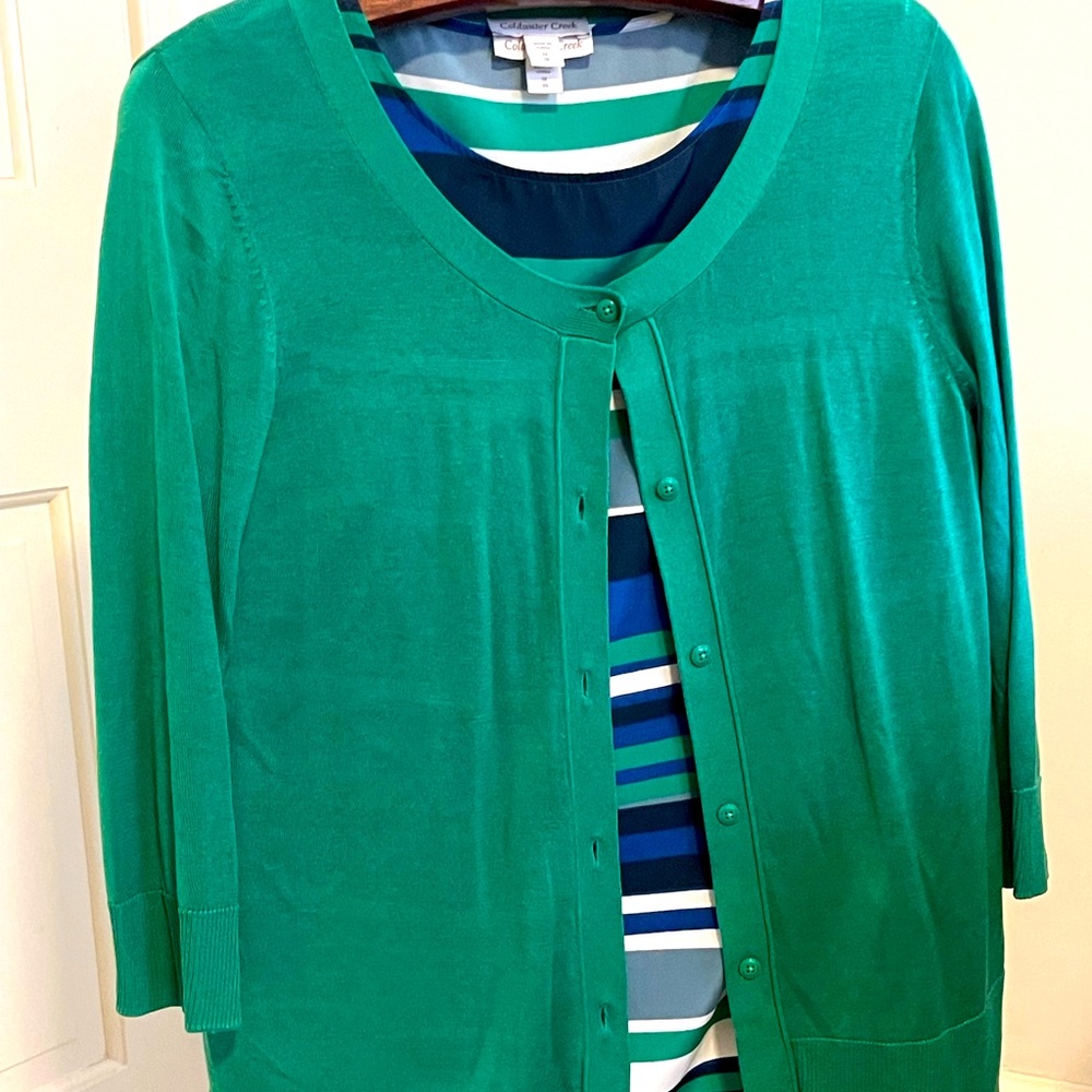 Green sweater with striped top.